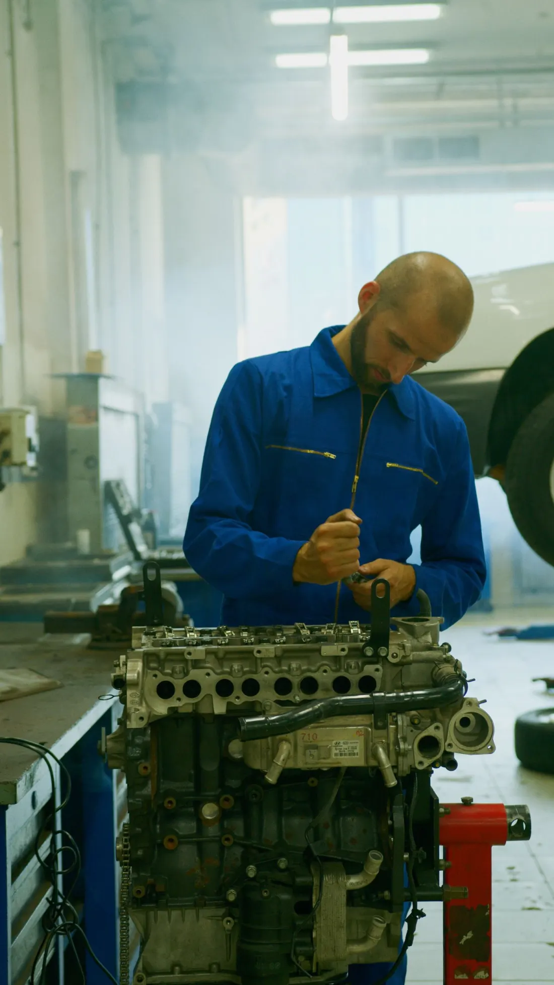 Automotive technician working on an engine assembly